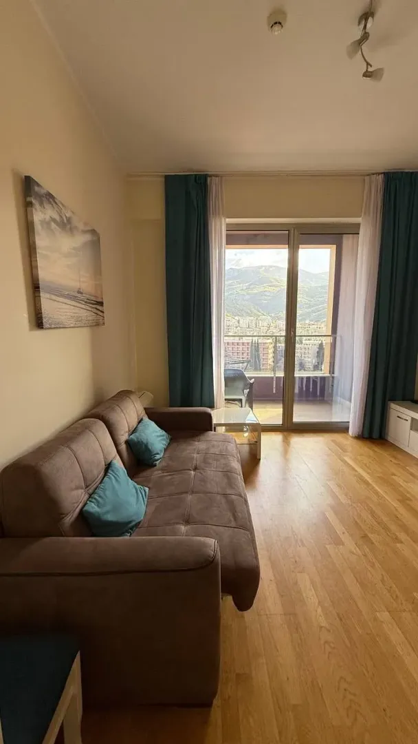 Living room with a sofa and access to the terrace.