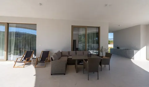 Covered terrace with seating furniture and sun loungers. - image 15