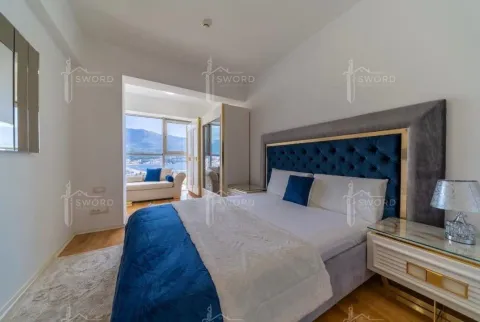 Furnished bedroom with a large double bed and a sea view. - image 4