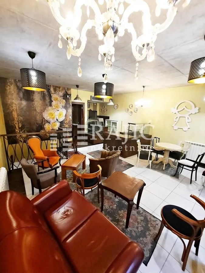 Furnished living room with seating area and tables.