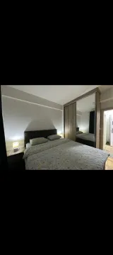 Furnished bedroom with a double bed and a fitted wardrobe with a mirror. - image 13