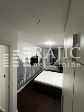 Furnished bedroom with a double bed and a fitted wardrobe. - image 12