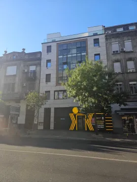 Street view of a modern residential building with commercial space on the ground floor. - image 6