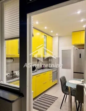 Modern kitchen with yellow units and a dining table. - image 10