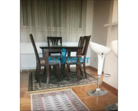 Dining area with a table, chairs and a rug near the window. - image 4