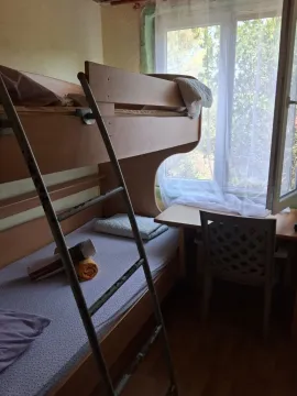 Children's bedroom with a bunk bed and a desk by the window. - image 8