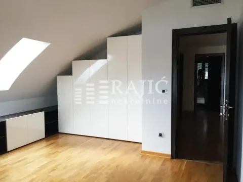 Bright bedroom with a built-in wardrobe and wooden flooring. - image 10