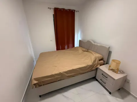 Bedroom with a double bed, nightstand, and curtains. - image 6