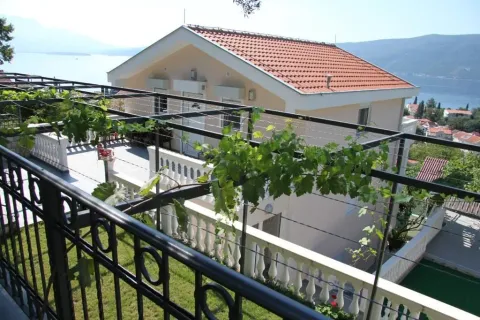 Pogled na kuću sa terasom i dvorištem okruženom zelenilom. - image 10