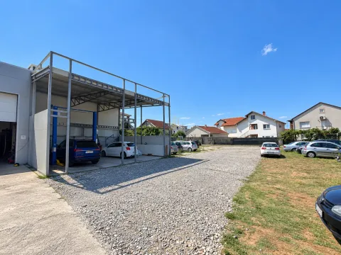 View of the exterior of the commercial building with a parking lot and a covered area. - image 4