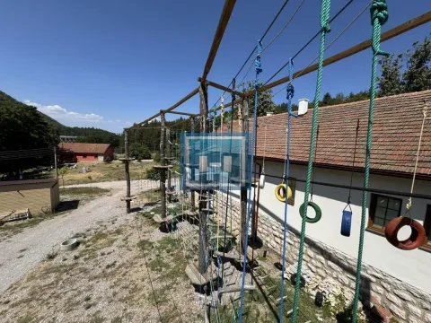 Yard with a wooden adventure playground next to the building. - image 9