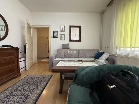 Dnevna soba sa garniturom za sedenje, komodom i prozorom. - image 4