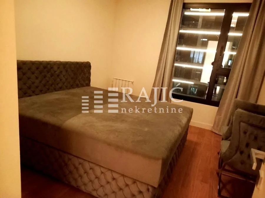 Bedroom with a double bed and a window.