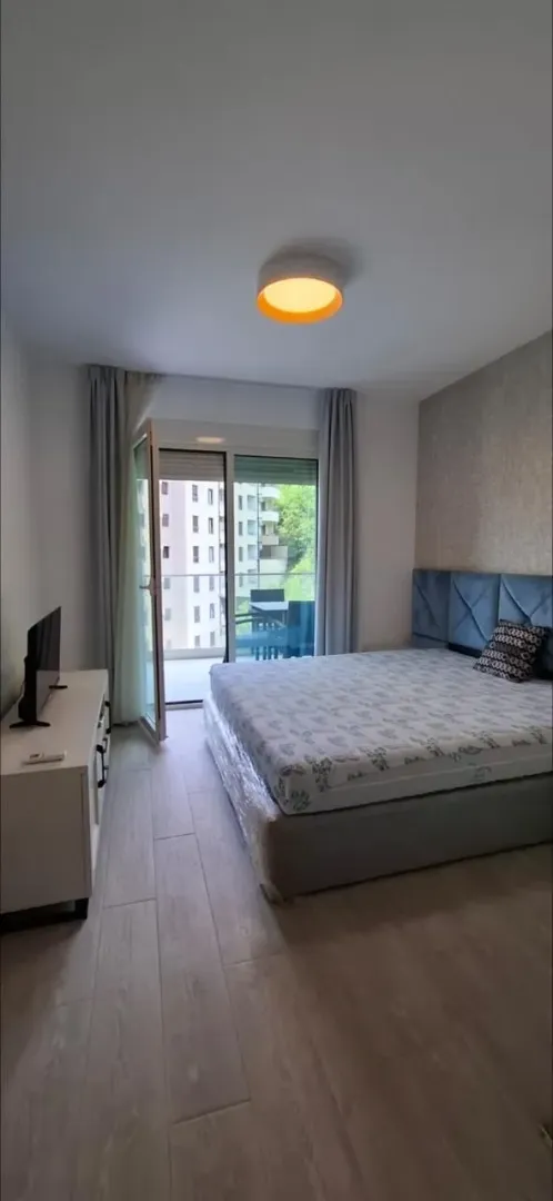 Bedroom with a double bed, dresser, and access to the terrace.