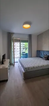 Bedroom with a double bed, dresser, and access to the terrace. - image 4