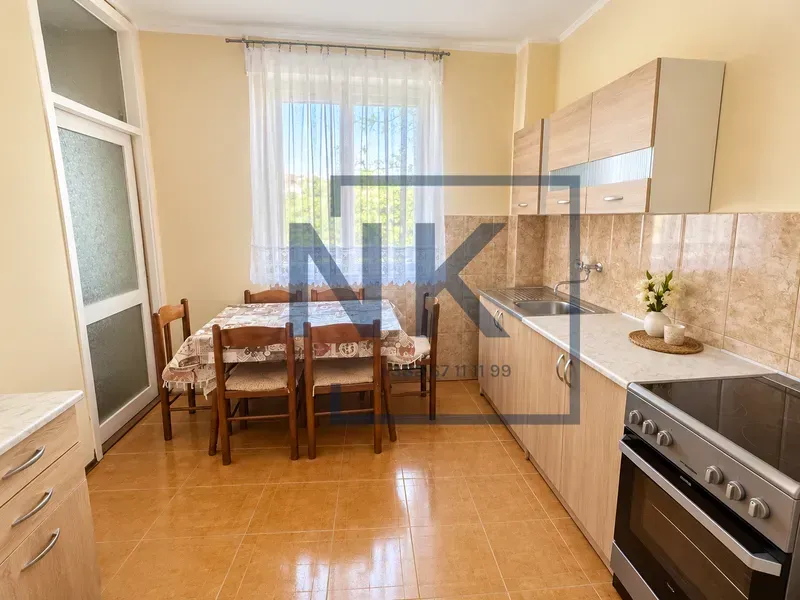 Kitchen with dining area and wooden cabinets.
