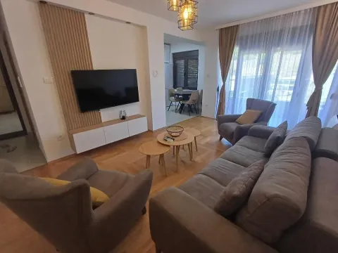 Spacious living room with sofa set, TV, and dining area in the background. - image 3