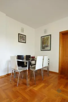 Dining area with a table, chairs, and parquet flooring. - image 5