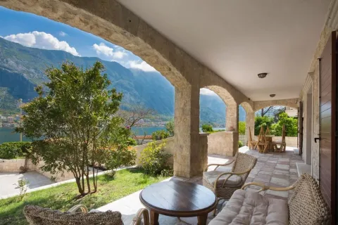 Spacious stone terrace with outdoor furniture and open views of the sea and mountains. - image 11