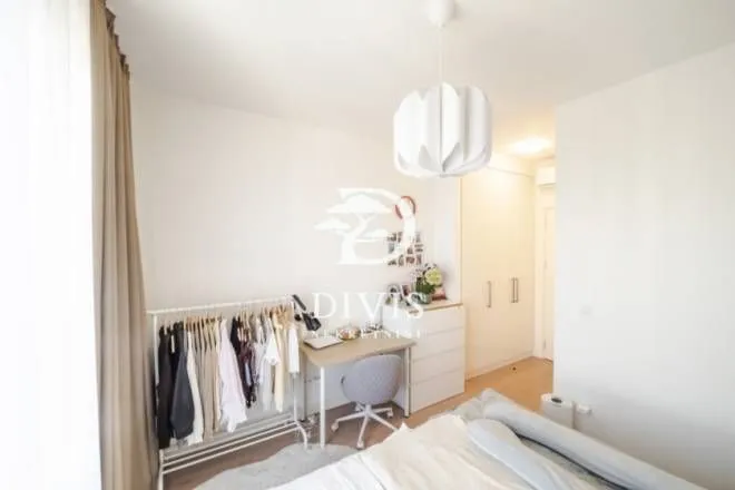 Bedroom with a desk, wardrobe, and bed.