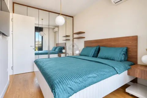 Modern bedroom with a double bed, wooden headboard, and a built-in mirrored wardrobe. - image 17
