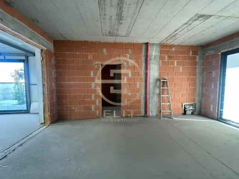 A view of an unfurnished room under construction with brick walls and a concrete ceiling. - image 7