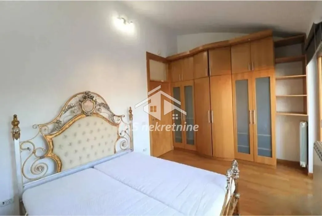 Bedroom with a double bed and a large wooden wardrobe.