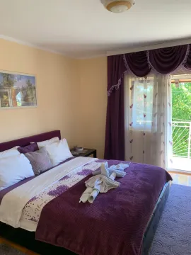 Bedroom with a double bed, purple curtains, and access to the terrace. - image 11