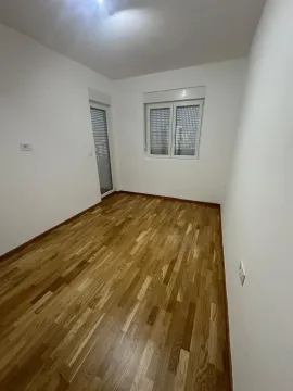 Empty room with hardwood floors, white walls, and access to a terrace. - image 6