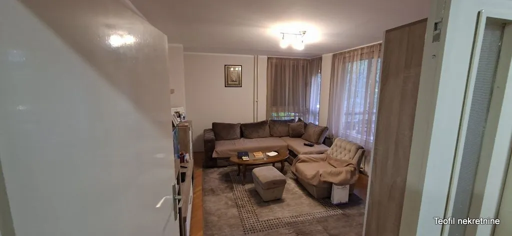 Dnevna soba sa garniturom za sedenje i stočićem.