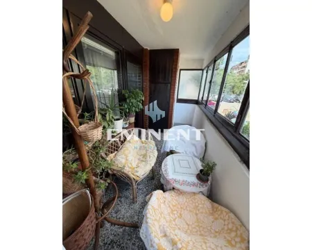 Enclosed balcony with seating furniture and plants. - image 17