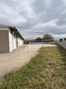 Exterior of the building with a concrete yard and lawn. - image 4