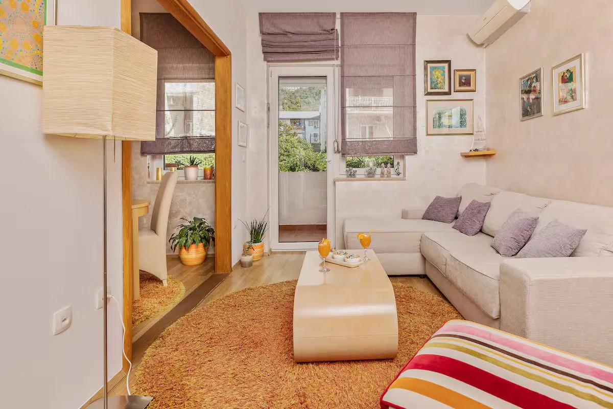 Living room with a sofa, coffee table, and a view of the terrace.