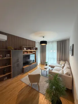 Modern and bright living room with a sofa, TV unit, and wooden wall panels. - image 9