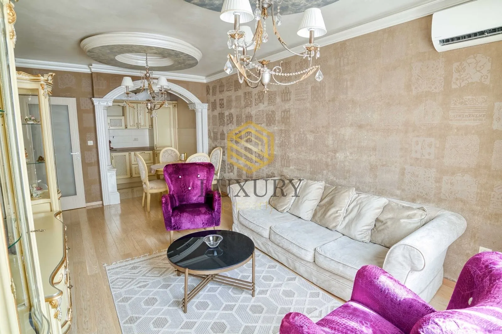 Spacious living room with sofa set and a view of the dining area.