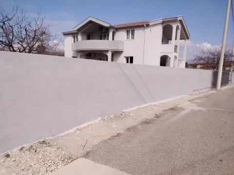 Exterior view of a two-story house with a fence. - image 16