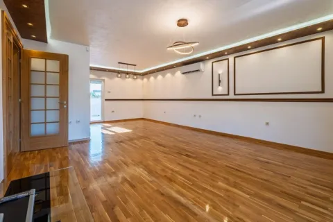 Empty living room with hardwood flooring, recessed lighting, and a door leading to the terrace. - image 3