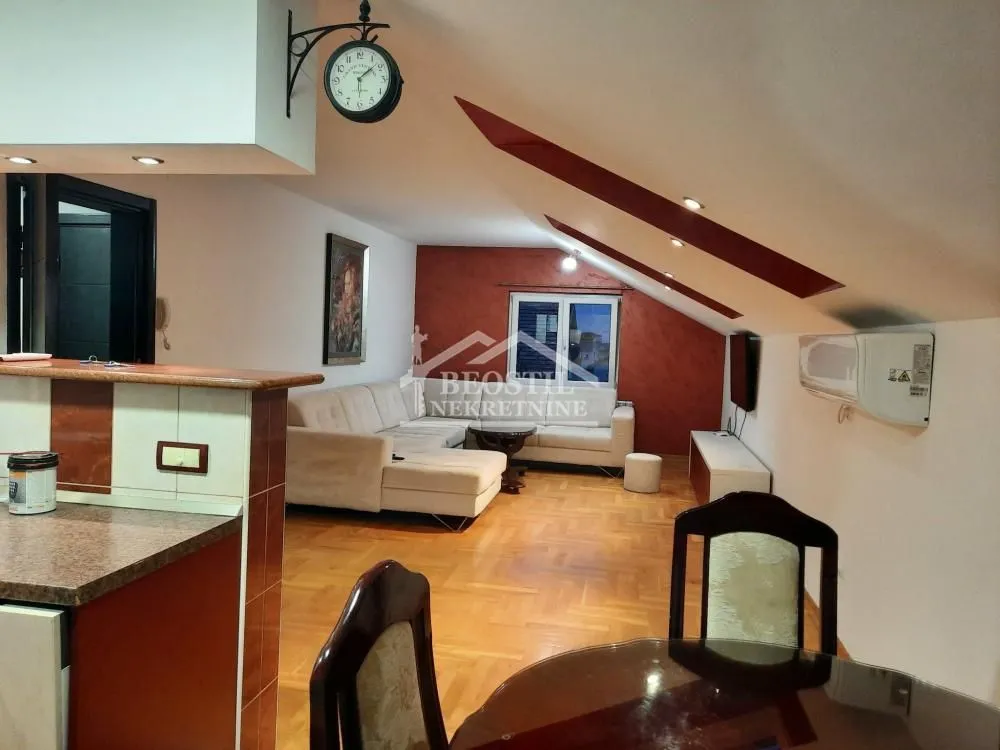 Living room with a sofa set and dining table in the attic.