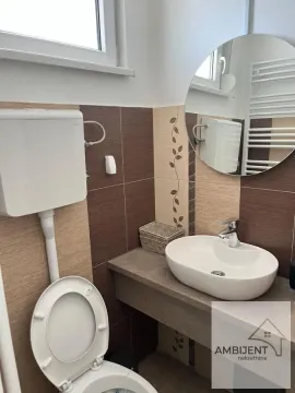 Bathroom with a sink, mirror, and toilet. - image 14