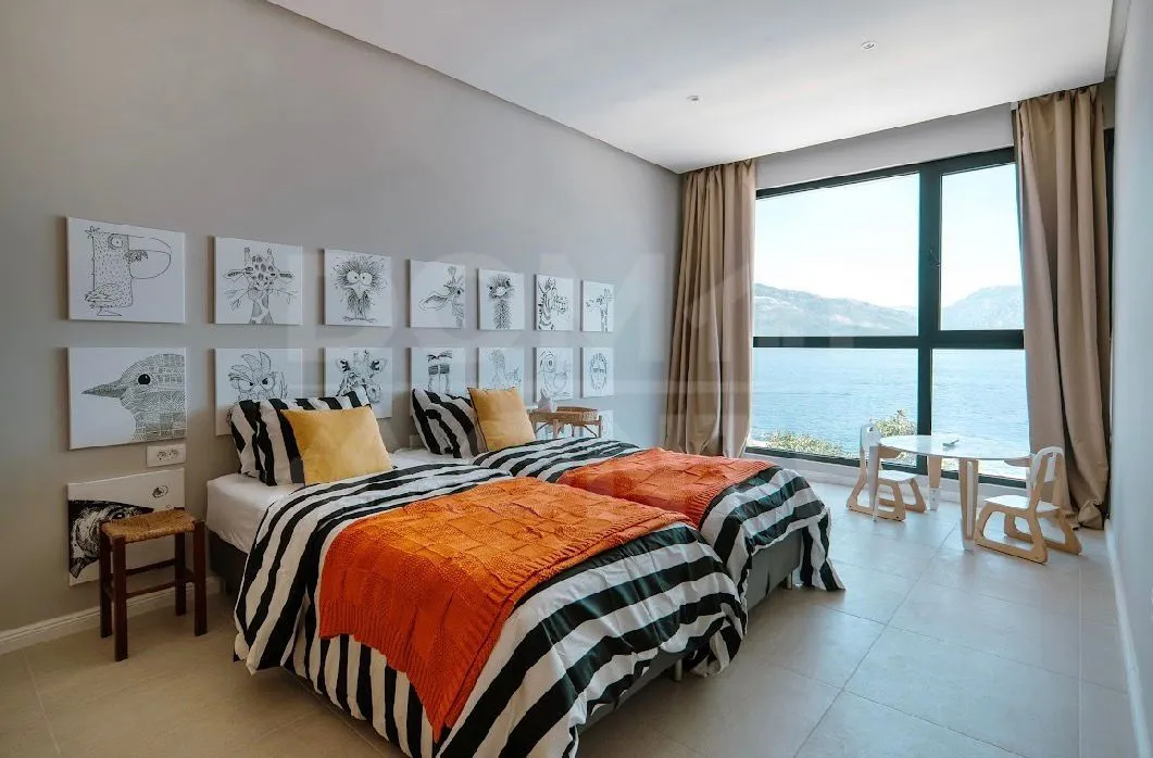 Children's bedroom with two beds and a sea view.