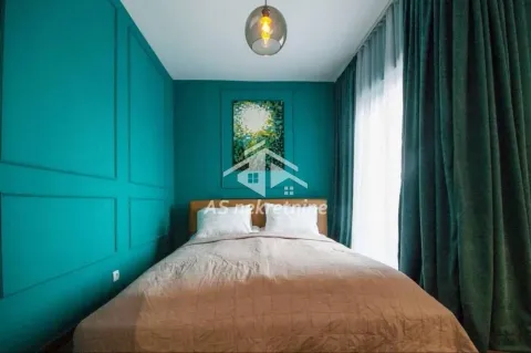 Modern bedroom with turquoise walls and a double bed. - image 8