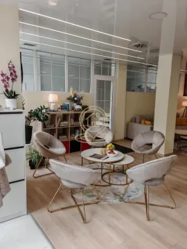 Living room with a seating area and modern lighting. - image 8