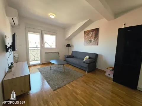 Living room with sofa, TV, and access to the balcony. - image 2