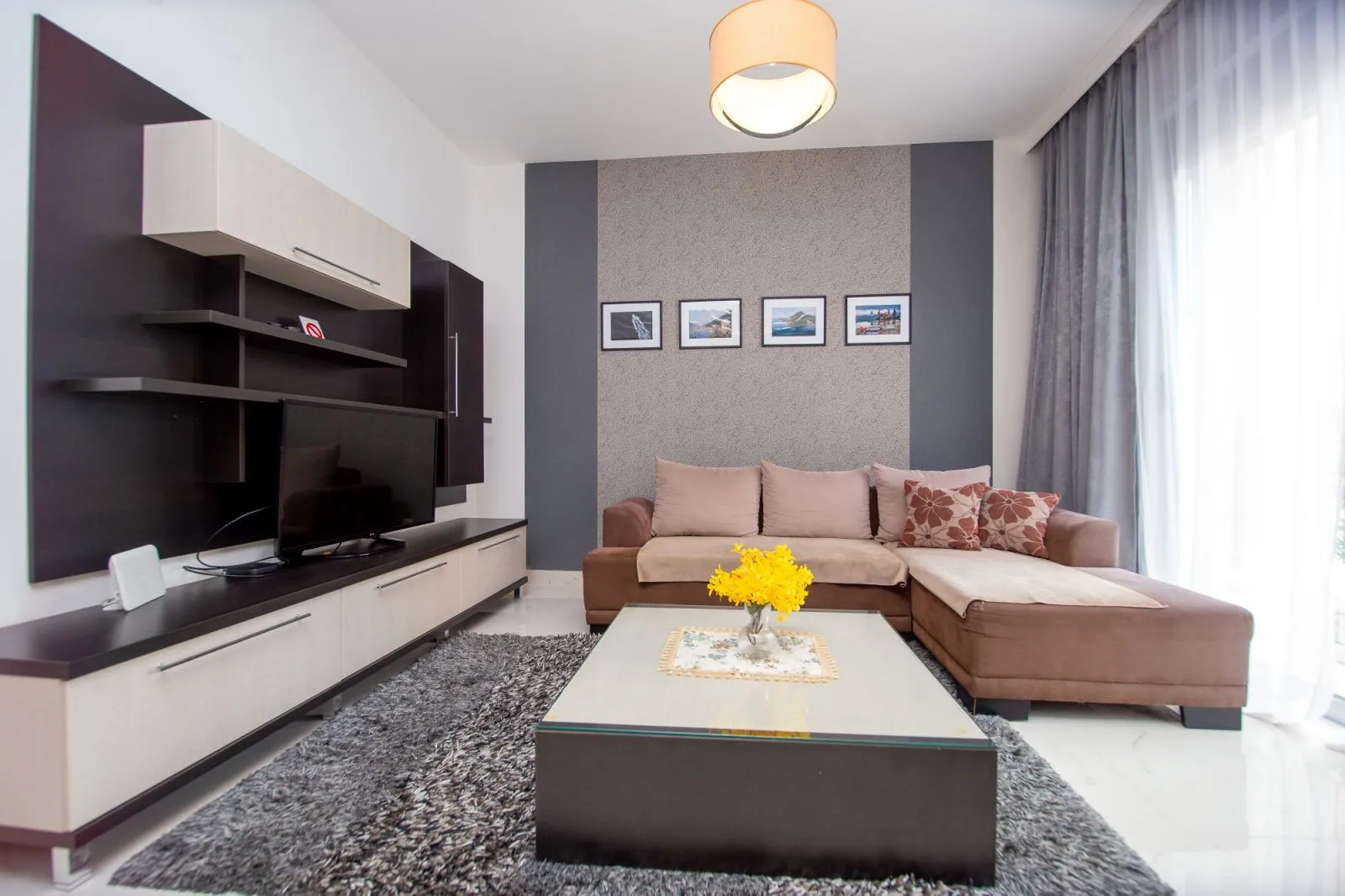 Furnished living room with a sofa, TV unit, and coffee table.