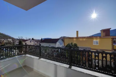 Spacious terrace with a view of surrounding houses and hills. - image 4