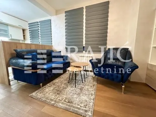 Furnished living room with sofa set and coffee table.