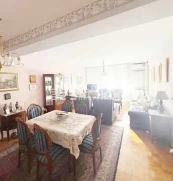 Spacious living room with a dining area and seating set. - image 3