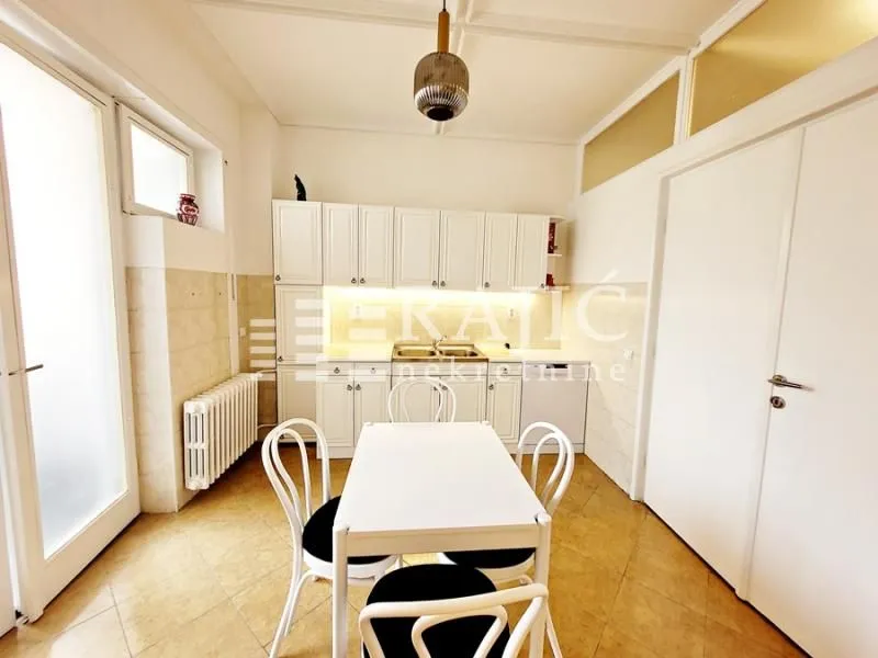 White kitchen with dining table and chairs.