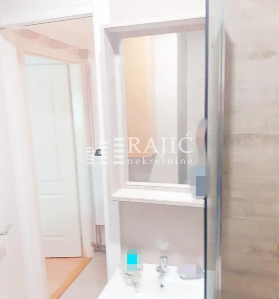 View of the sink with a mirror in the bathroom.