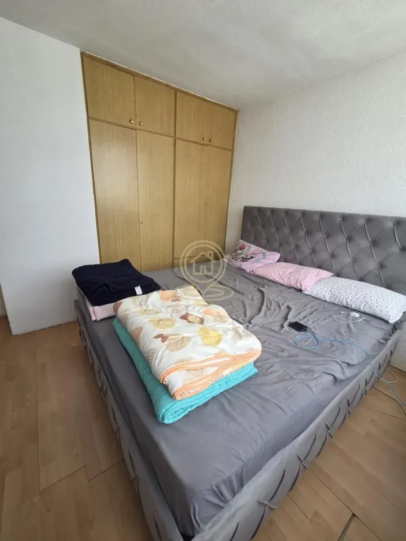 Bedroom with a double bed and a built-in wardrobe.